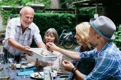 Group of friends enjoying a meal together outdoors